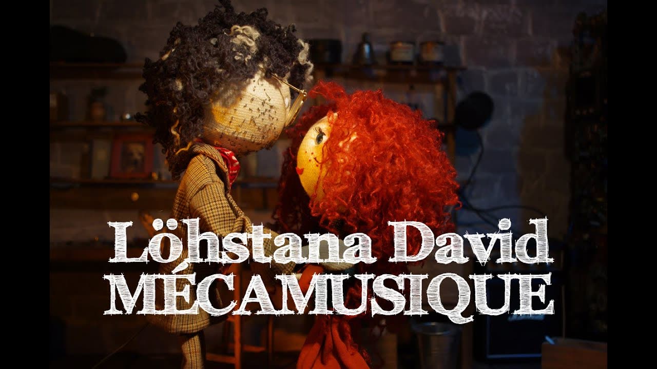 Still from the stop-motion film “Mécamusique”: the puppet musician beside a red-haired puppet