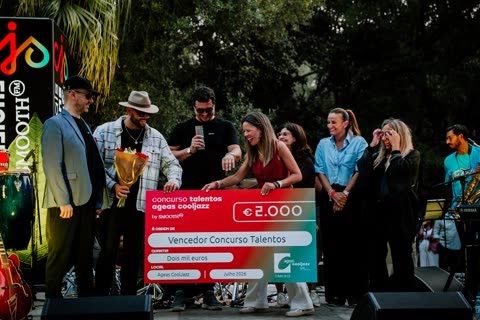 The Brothers on an outdoor stage receiving the talent competition winners’ cheque